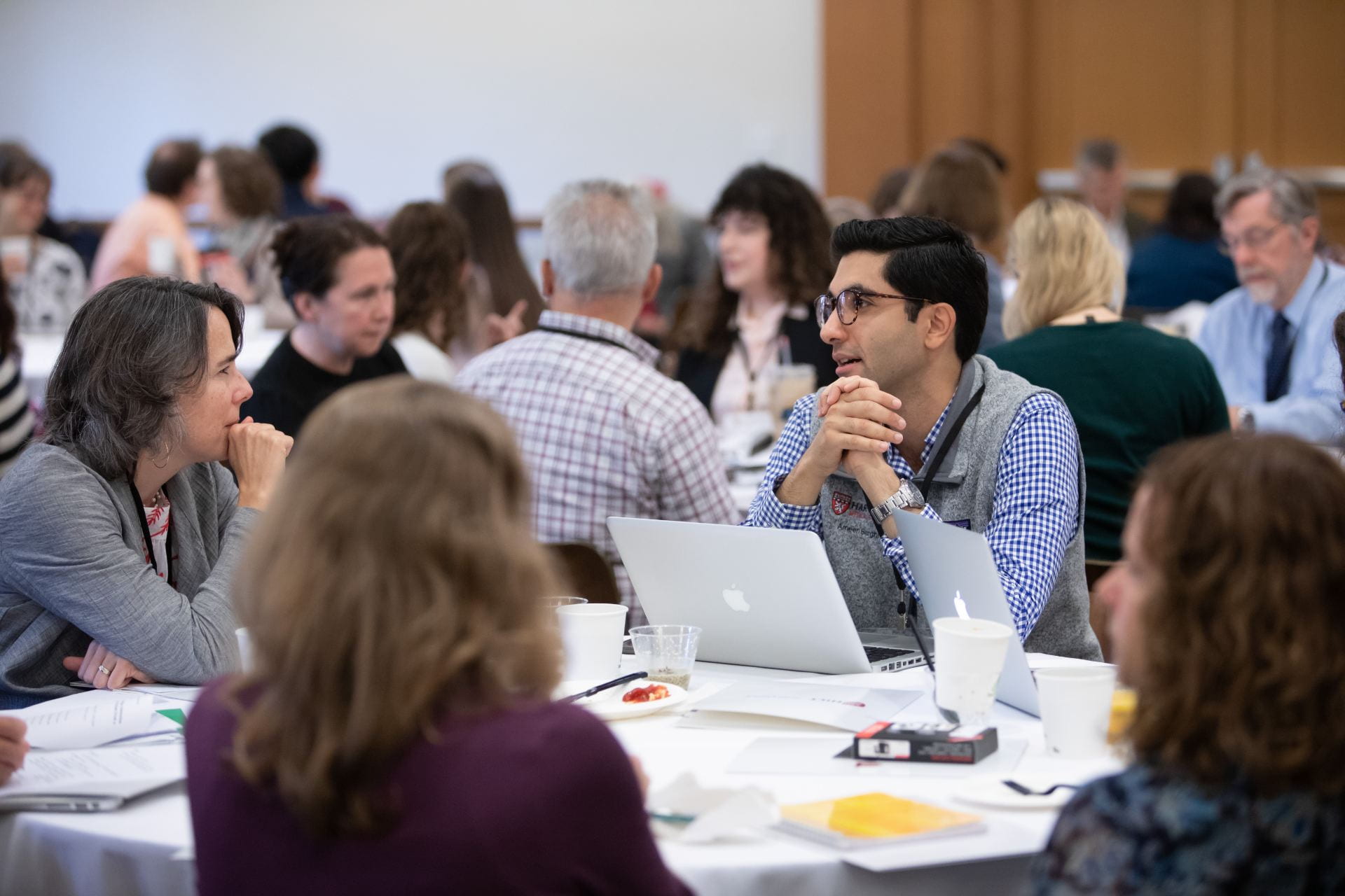 Attendees at 2019 HILT Conference speak at round tables.